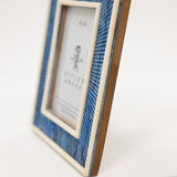 Decorative picture frame with blue and brown design on a white background