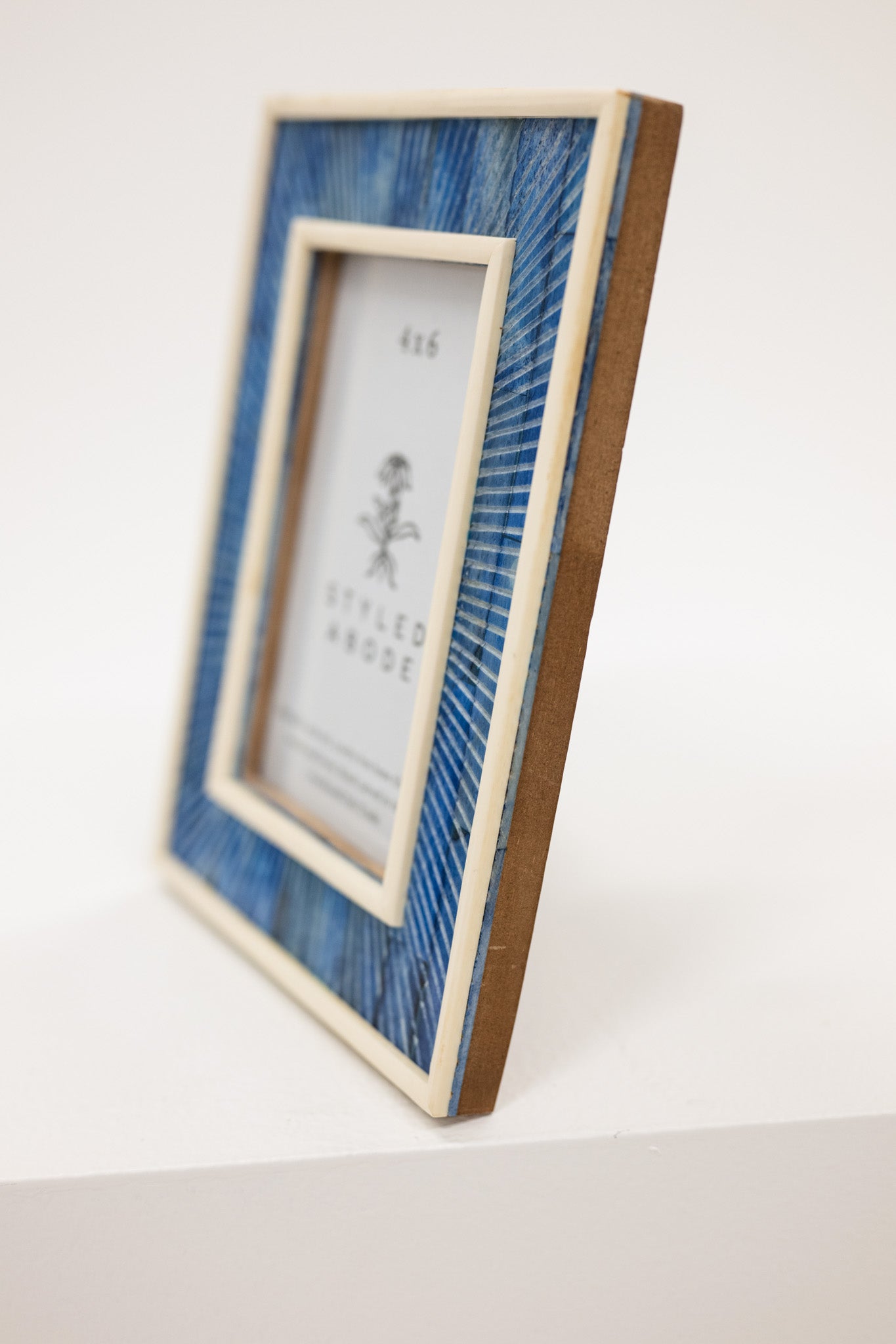 Decorative picture frame with blue and brown design on a white background