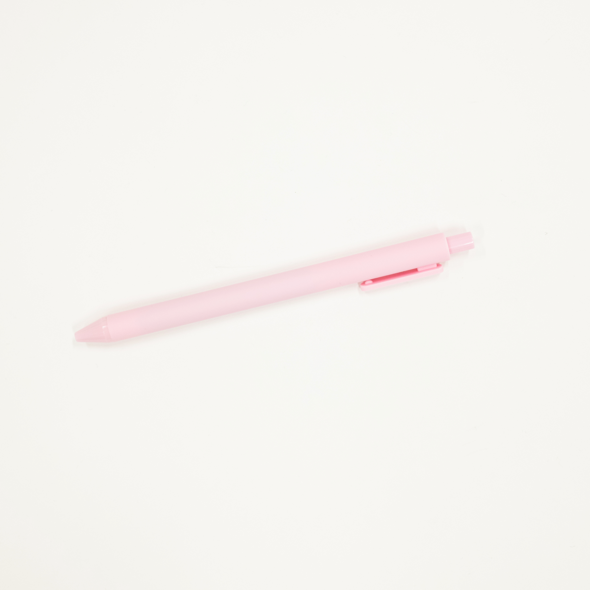 Pink pen on a white background