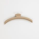 Beige hair clip on a white background