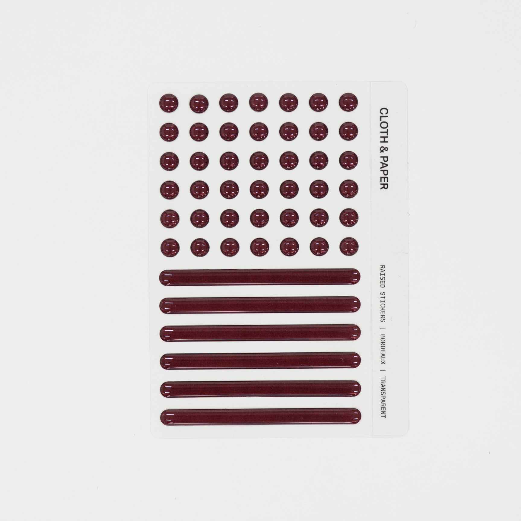 Sheet of maroon raised stickers on a white background with 'Cloth & Paper' branding.