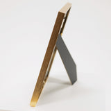 easel on the back of brass picture frame