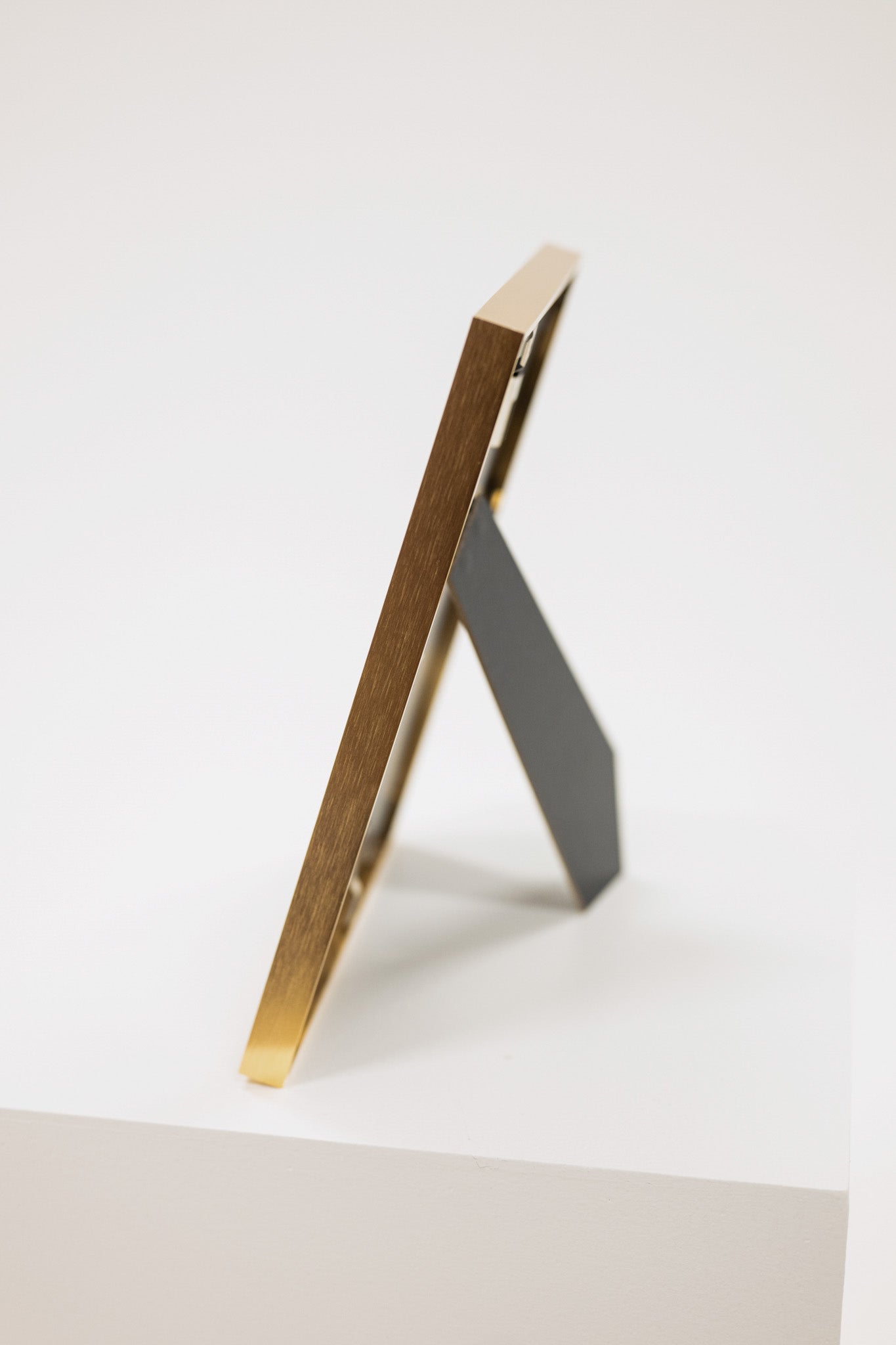 easel on the back of brass picture frame
