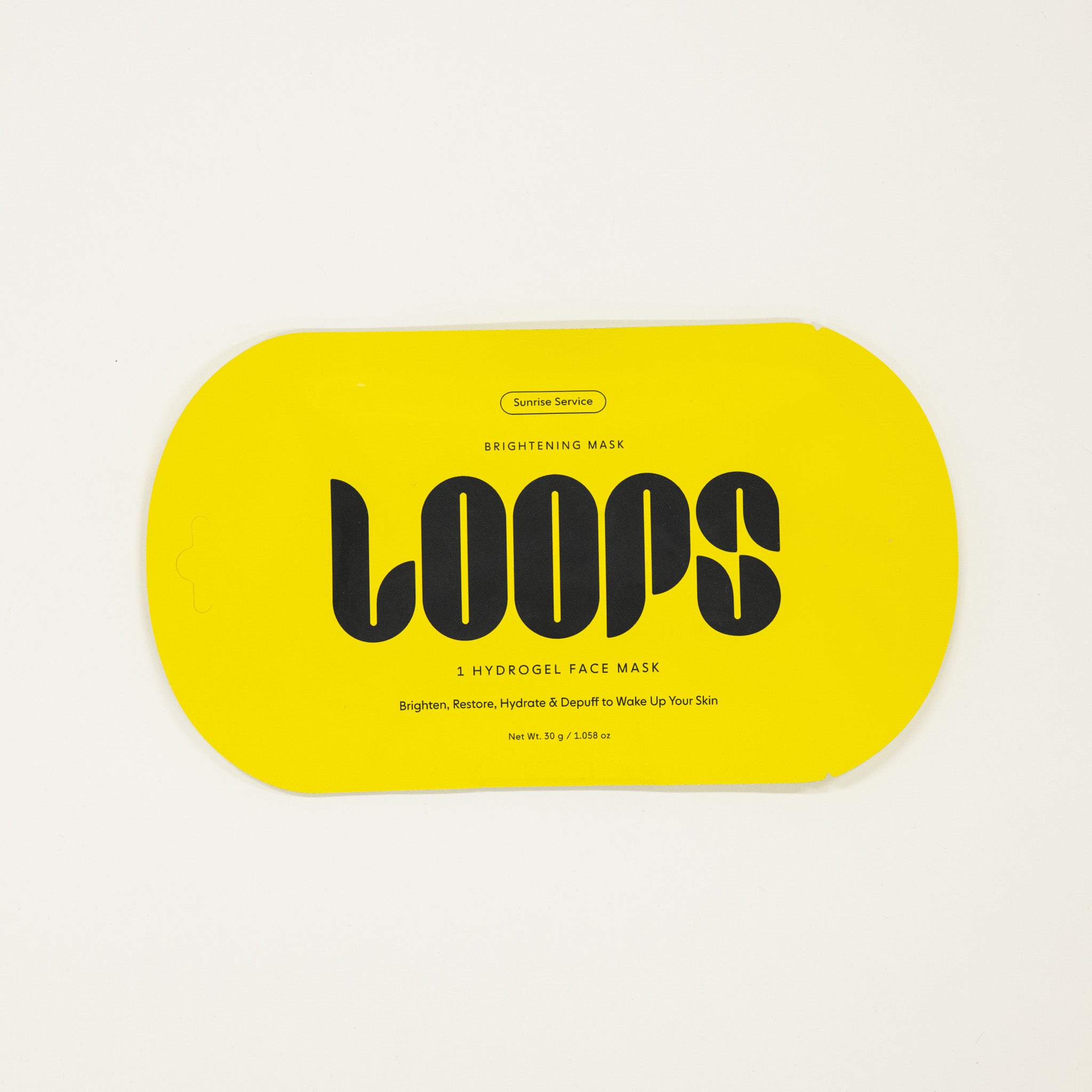 Yellow packaging of LOOPS brightening mask on a white background