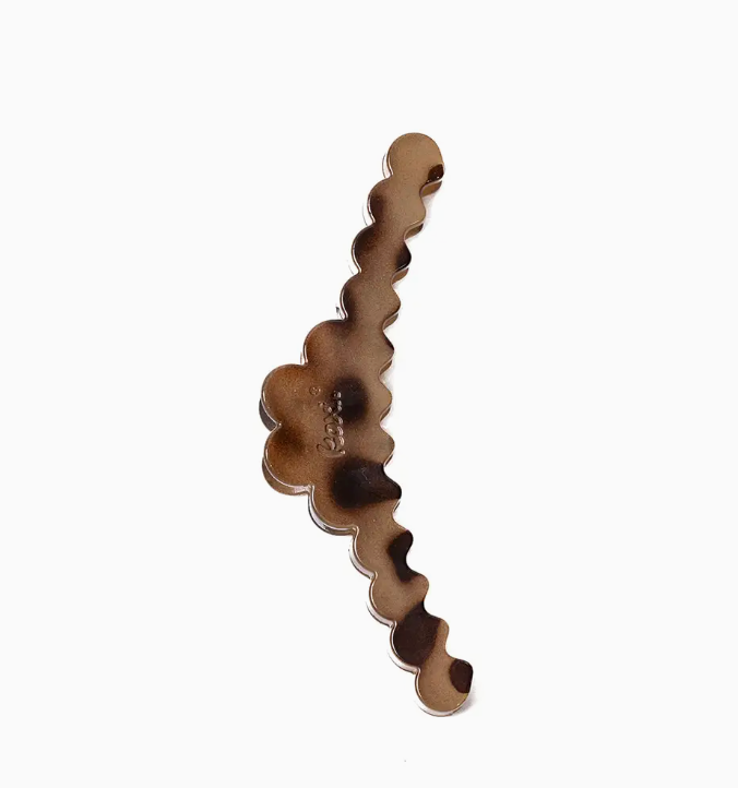 A single scalloped wavy hair claw clip in a brown and black tortoiseshell pattern, shown on a plain white background.