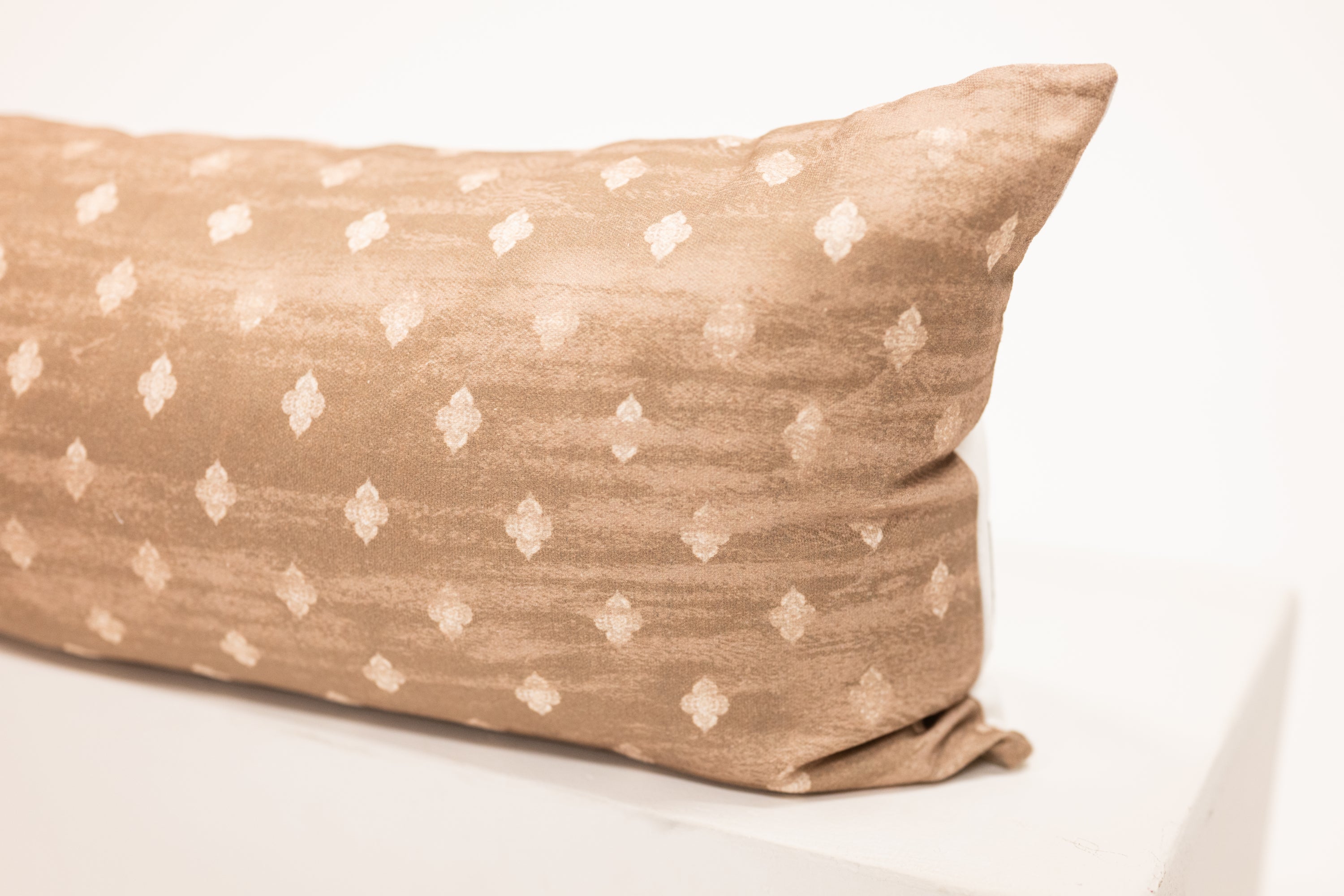 light brown lumbar pillow with diamond block pattern print