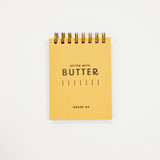 Butter logo printed on a small yellow pocket notebook.