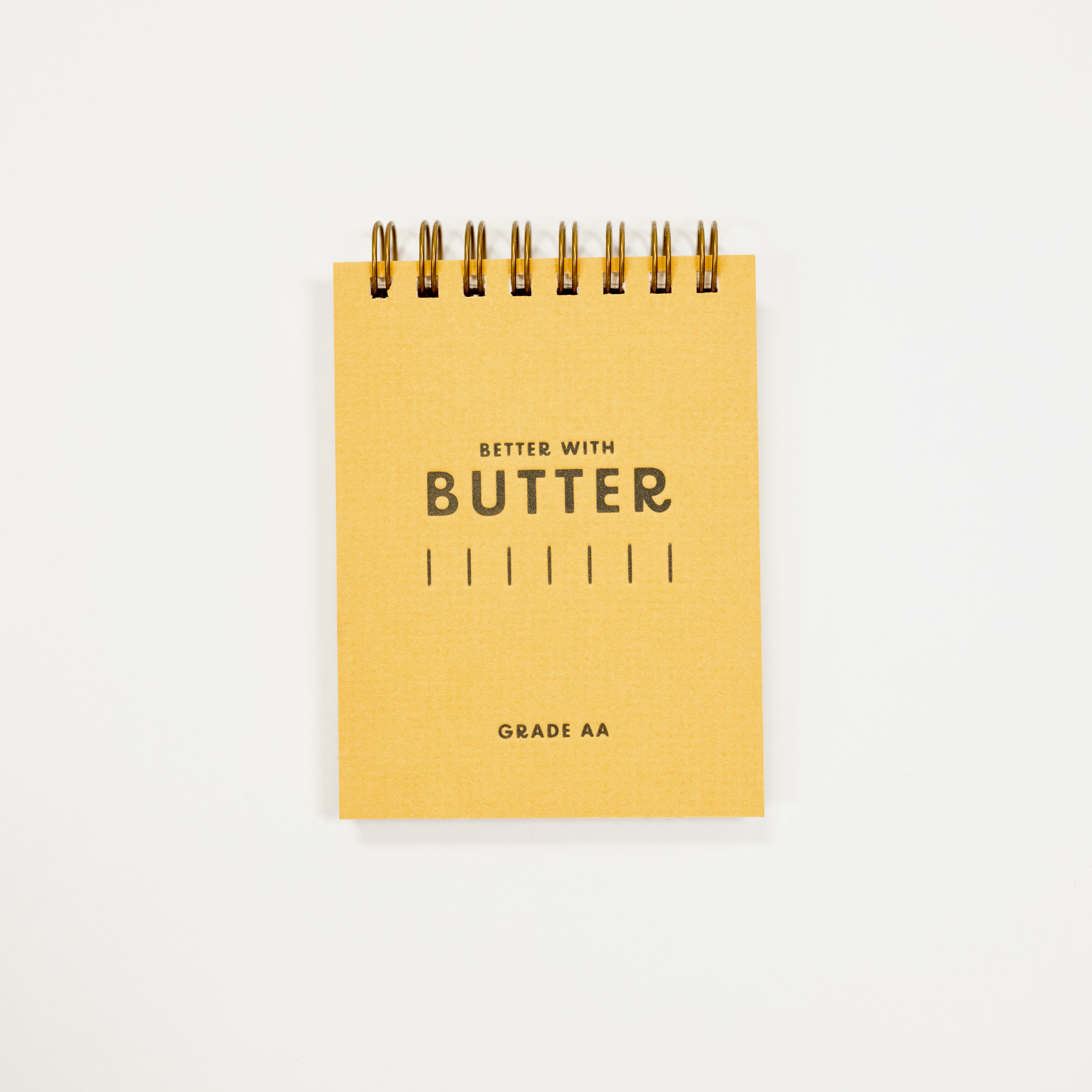 Butter logo printed on a small yellow pocket notebook.