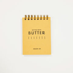 Butter logo printed on a small yellow pocket notebook.