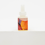 A small bottle of Becki Owens Caramel + Clove fragrance oil with a white dropper cap, set against a clean white background. Fall fragrance for Pura.