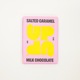 Pink chocolate bar packaging with yellow text on a white background