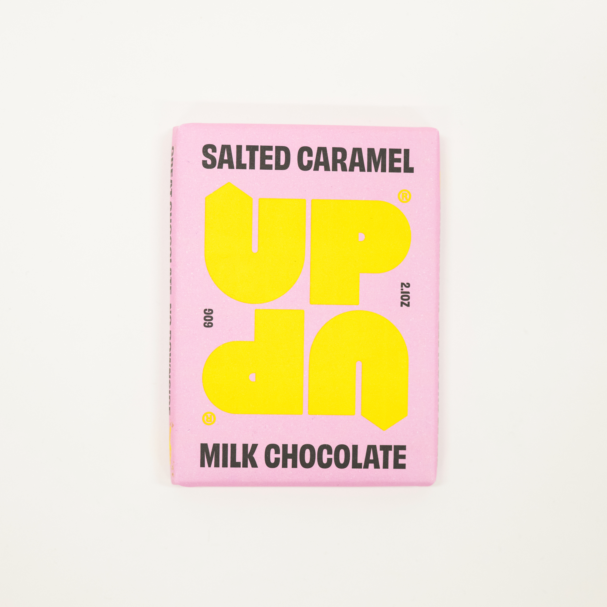 Pink chocolate bar packaging with yellow text on a white background