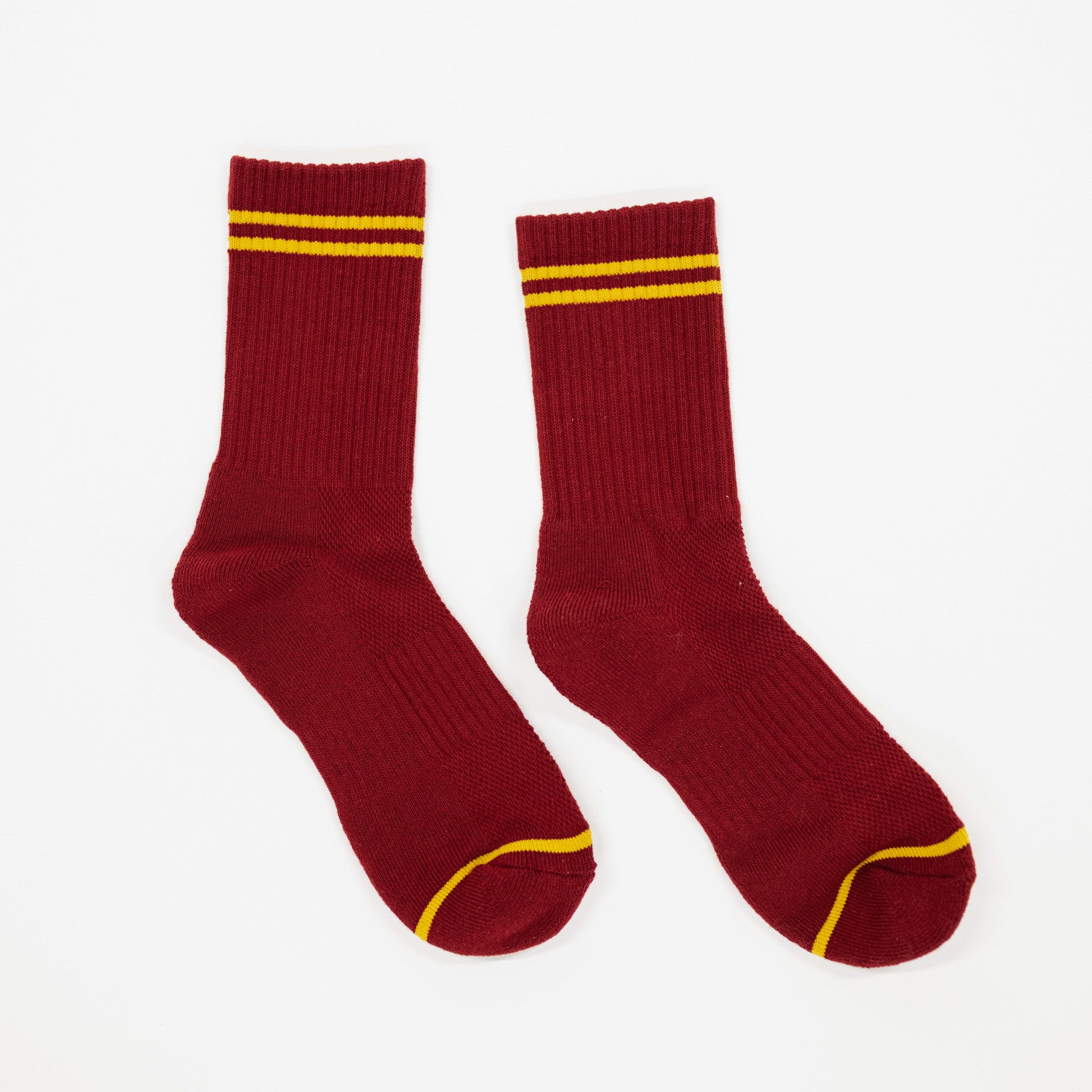 deep cardinal red socks with yellow stripes. from the brand name le bon shoppe