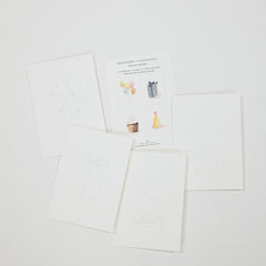 A set of white printable or watercolor birthday cards with simple line drawings and small illustrated accents, arranged on a light gray background. One card shows balloons, another a gift, another a cupcake, and another a party hat.