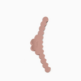 A dusty rose hair claw clip with a scalloped edge design, shown on a plain white background.
