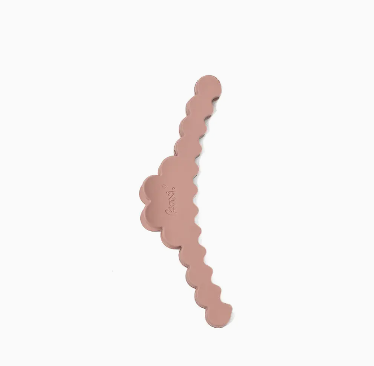 A dusty rose hair claw clip with a scalloped edge design, shown on a plain white background.
