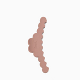 A dusty rose hair claw clip with a scalloped edge, shown on a plain white background.