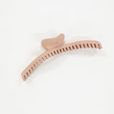 Pink hair comb on a white background