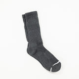 A grey crew sock with a red and white 'obey' logo patch on the cuff, displayed against a solid white background.