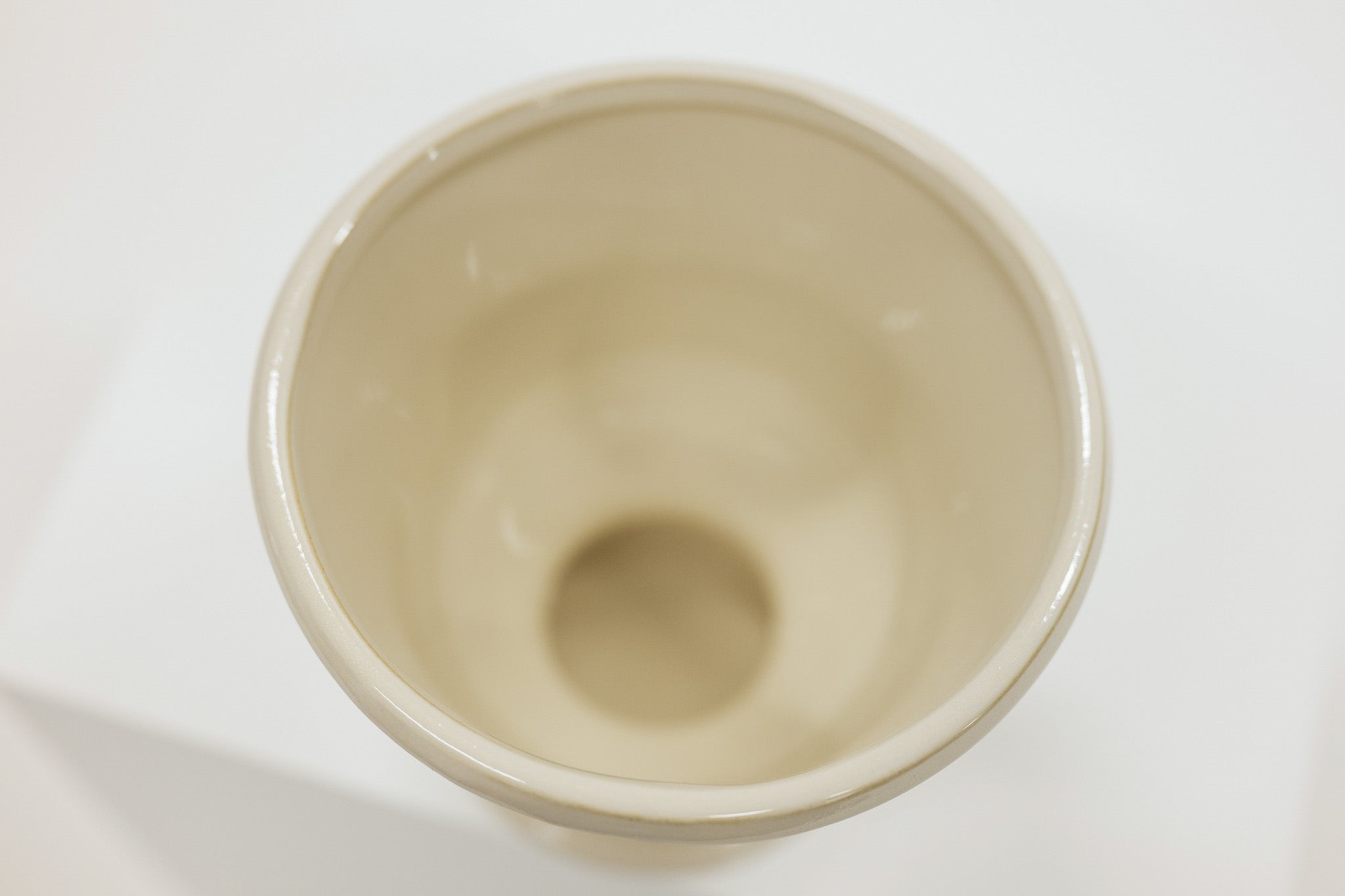Beige ceramic compote on a white background