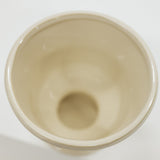 Beige ceramic compote on a white background