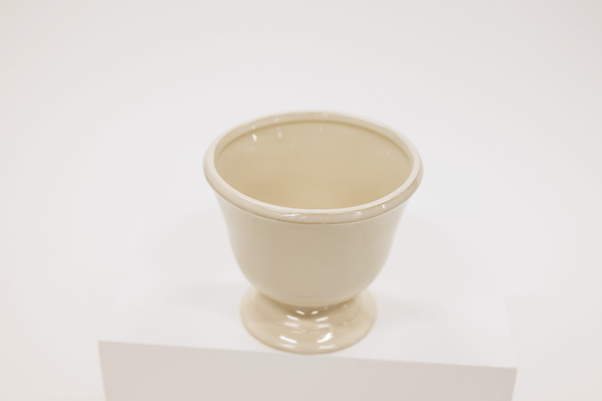 Beige ceramic compote on a white background