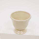 Beige ceramic compote on a white background