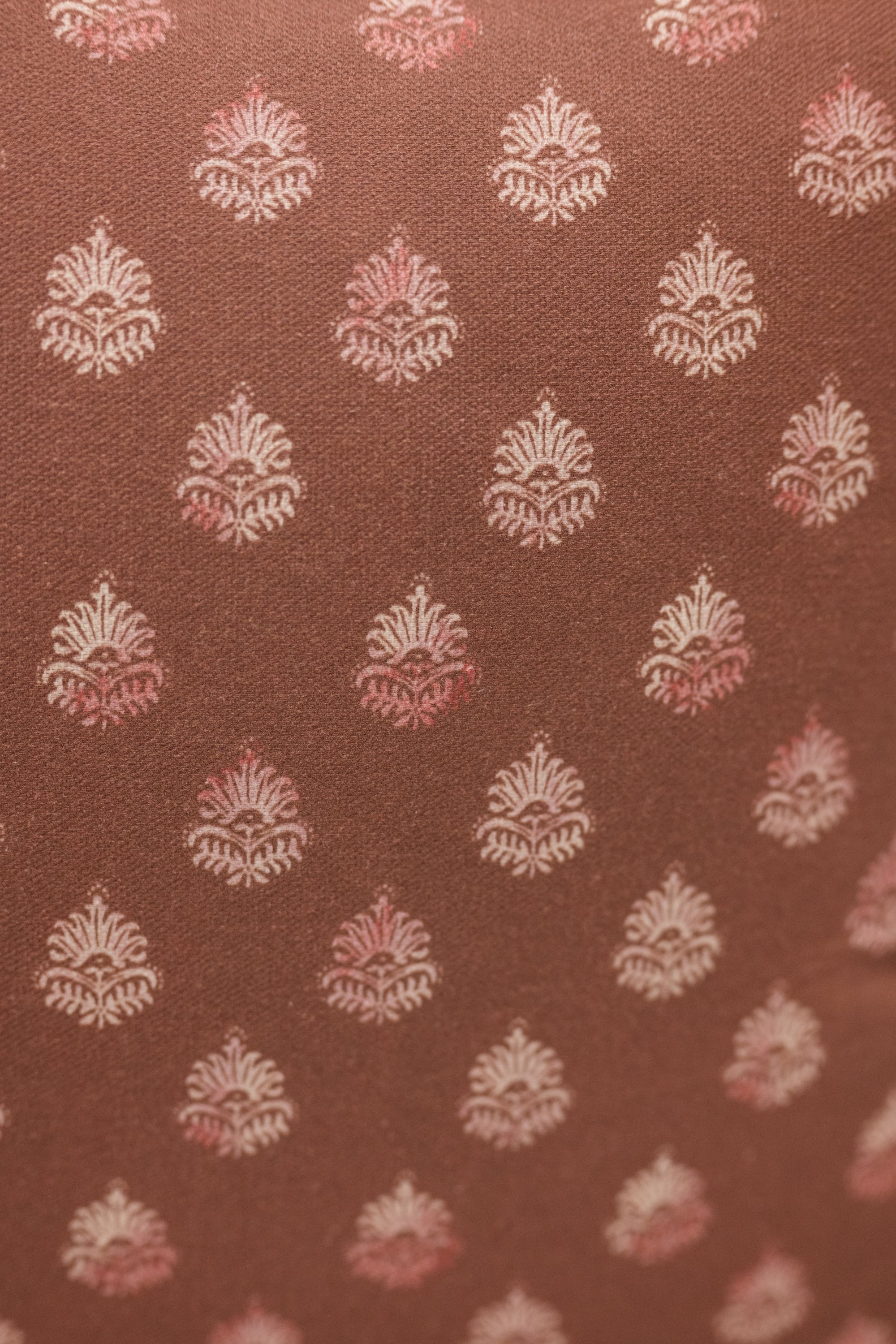 Brown fabric with white and pink floral pattern