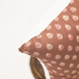 clay colored square pillow with block print pattern 