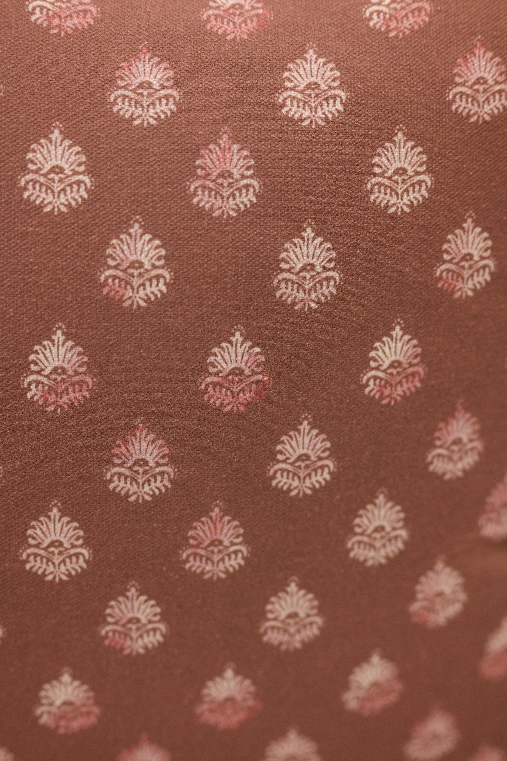 Brown fabric with white and pink floral pattern