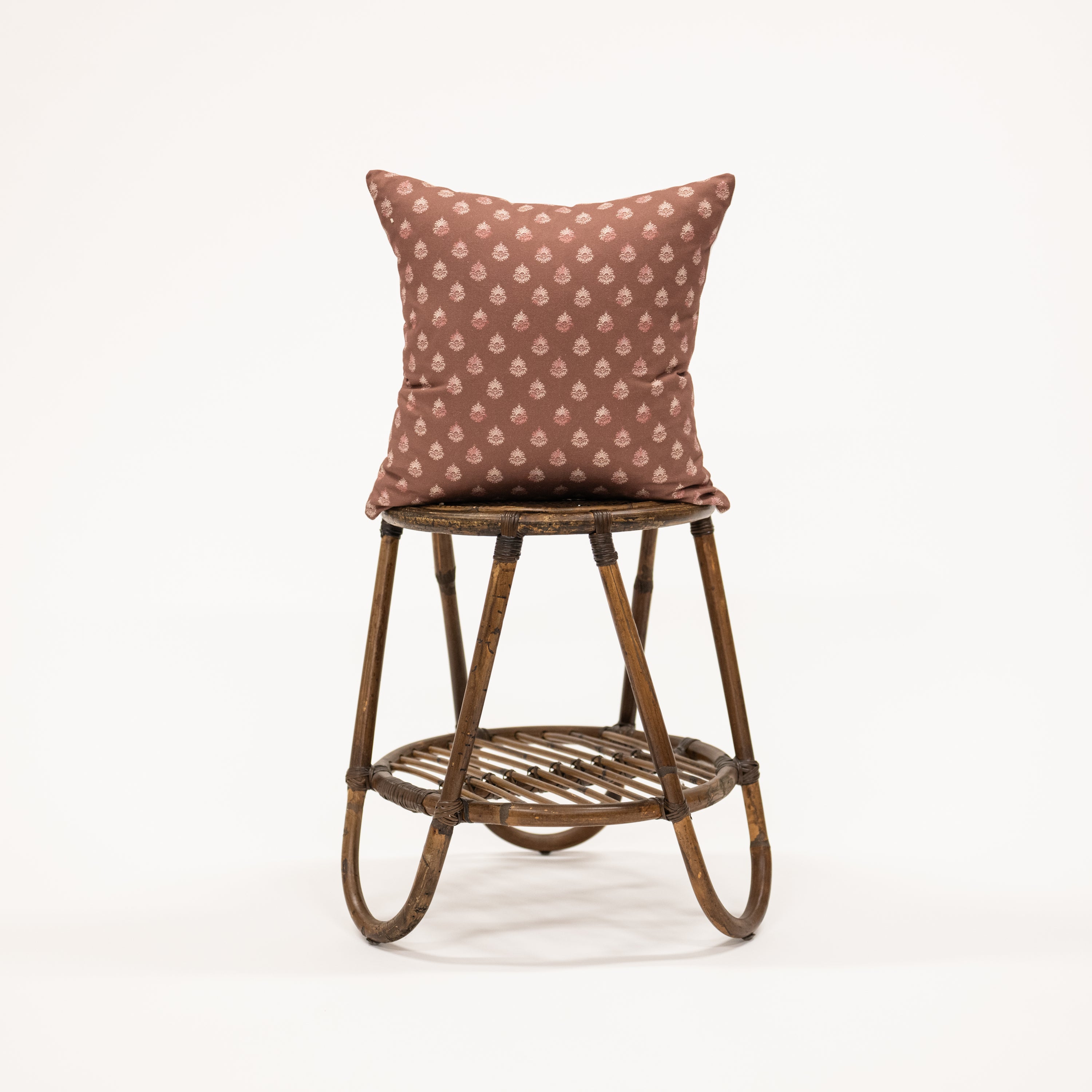 clay colored square pillow with block print pattern