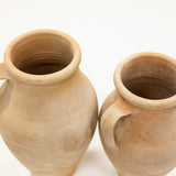 Two terracotta pots on a white background