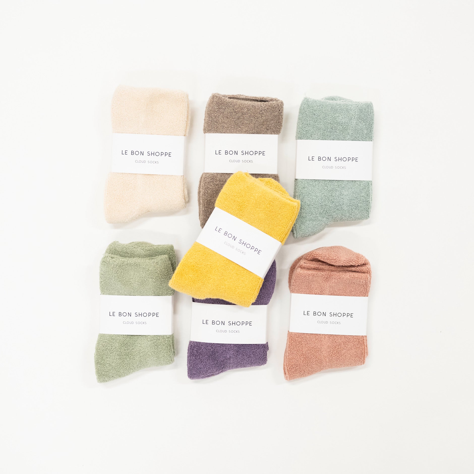 A collection of socks in various colors, neatly arranged on a white surface, each with a label indicating the size range of 6-10.