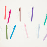 Colorful pens arranged on a white background