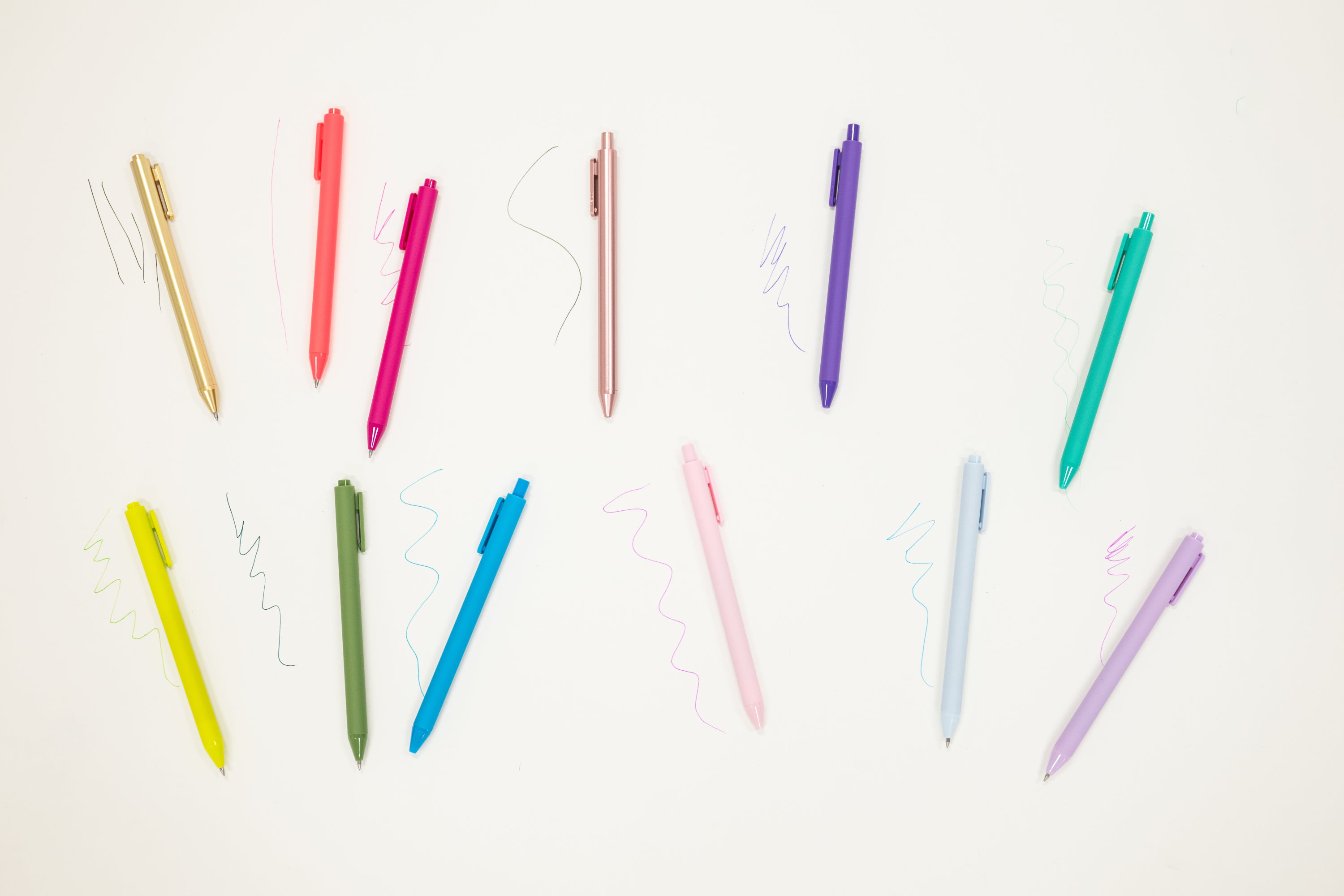 Colorful pens arranged on a white background