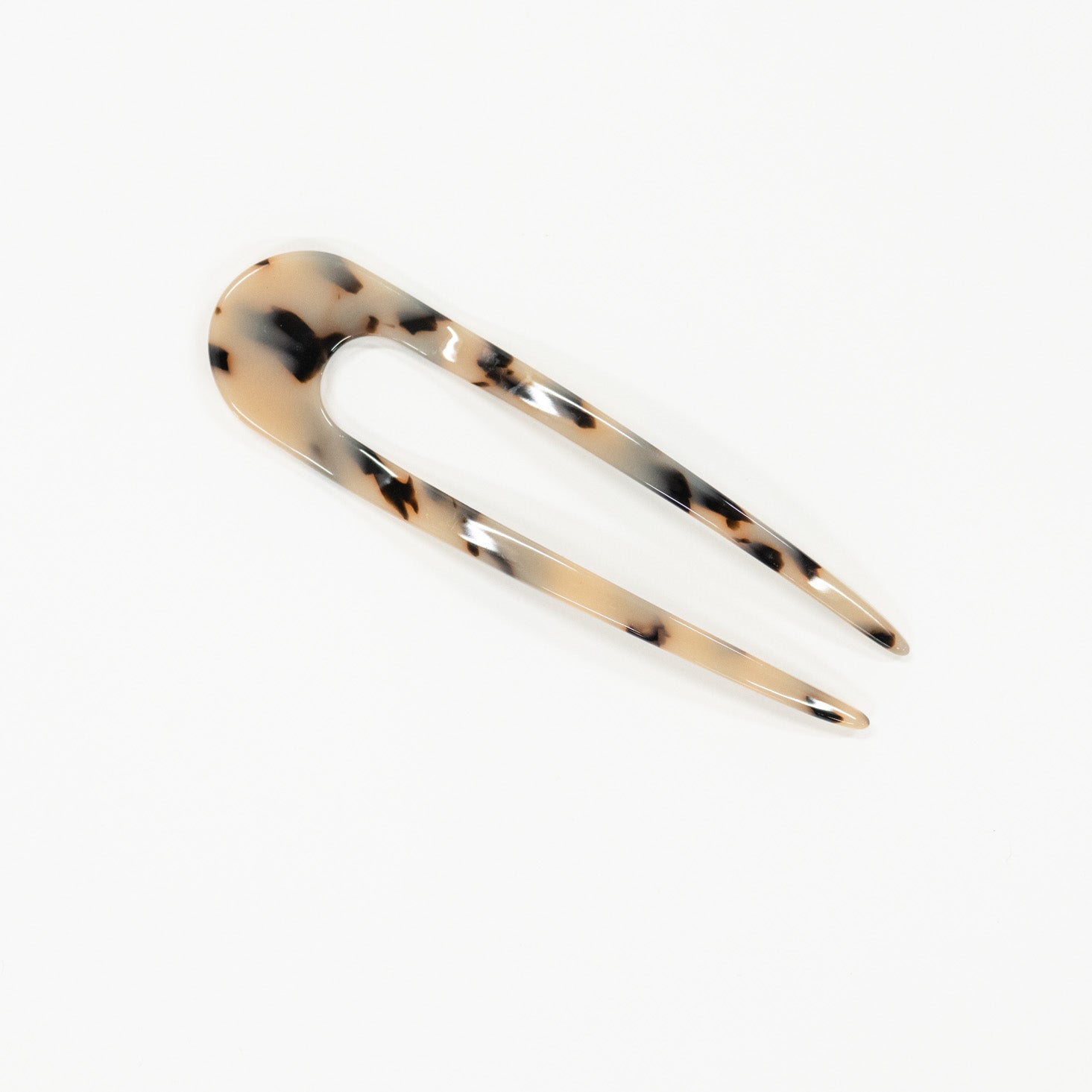 Tortoiseshell patterned hair clip on a white background