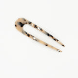 Tortoiseshell patterned hair clip on a white background