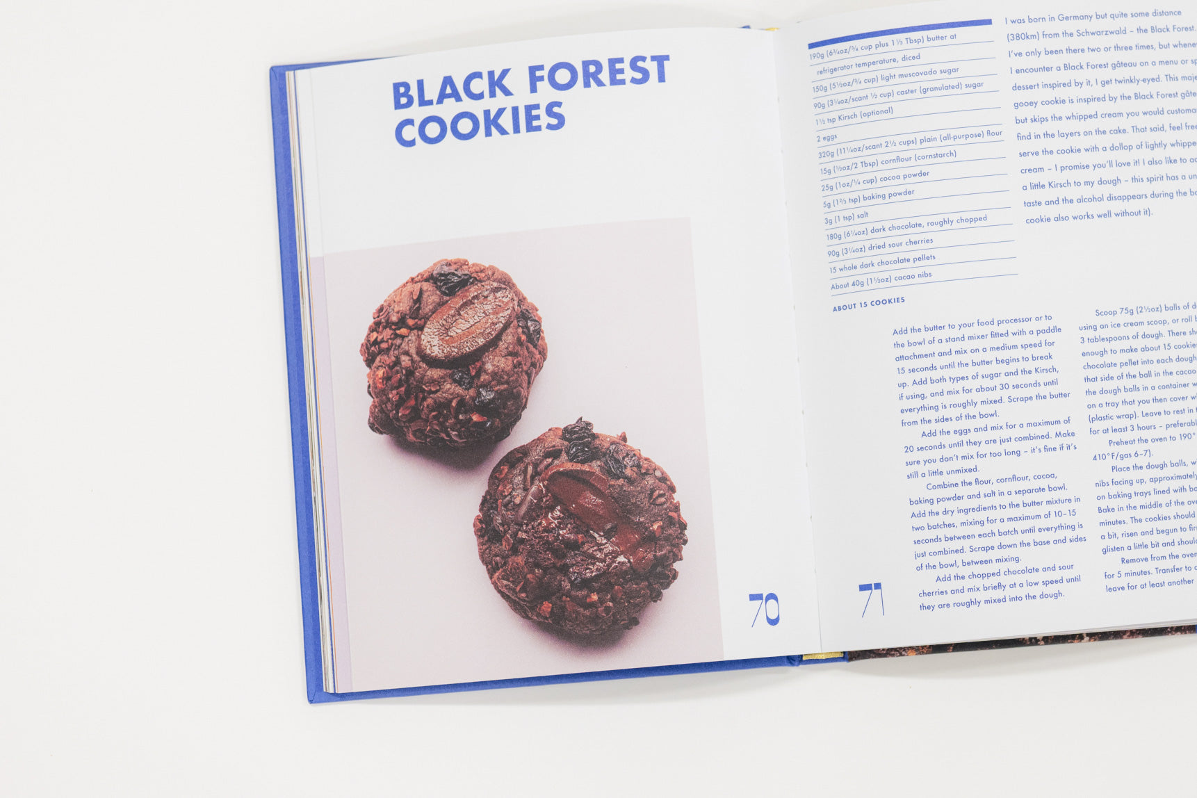 Open cookbook showing a recipe for Black Forest Cookies with two cookies displayed.