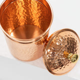 Copper container with a lid on a white background