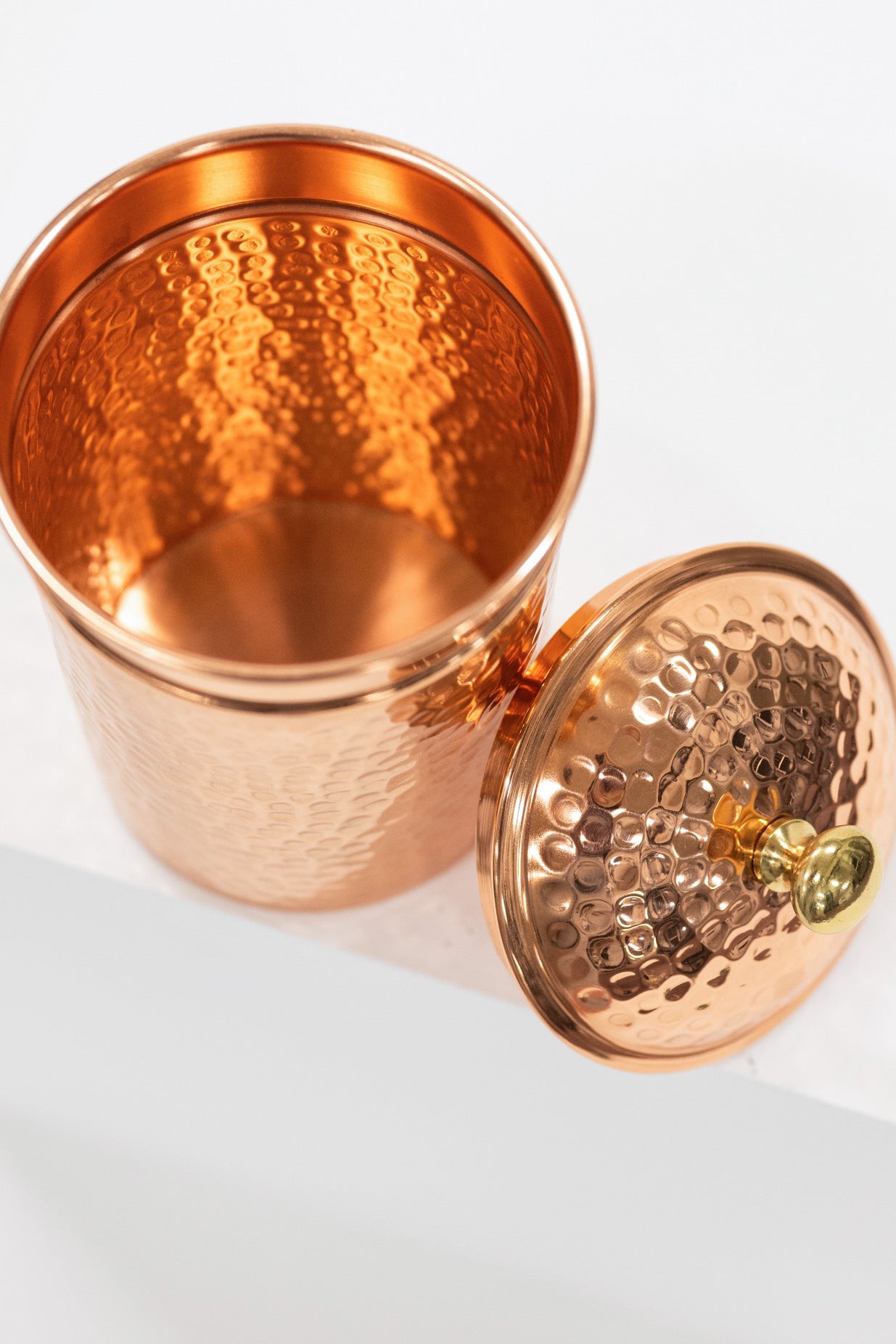 Copper container with a lid on a white background