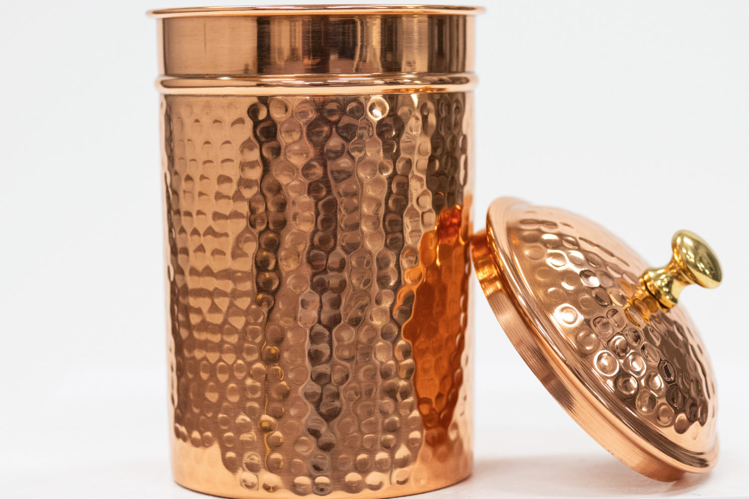 Copper jar with a lid on a white background