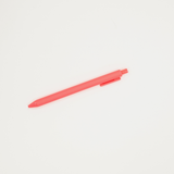 Red coral pen on a light gray background