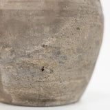 Close-up of a rustic, textured gray cumin pot on a clean white background.