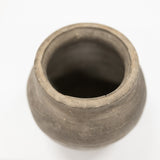 A small round clay pot with a wide, slightly flared rim, shown from a top-down perspective on a plain white background.