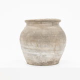 A small rustic clay pot with a wide rim and rounded body, shown against a plain white background.