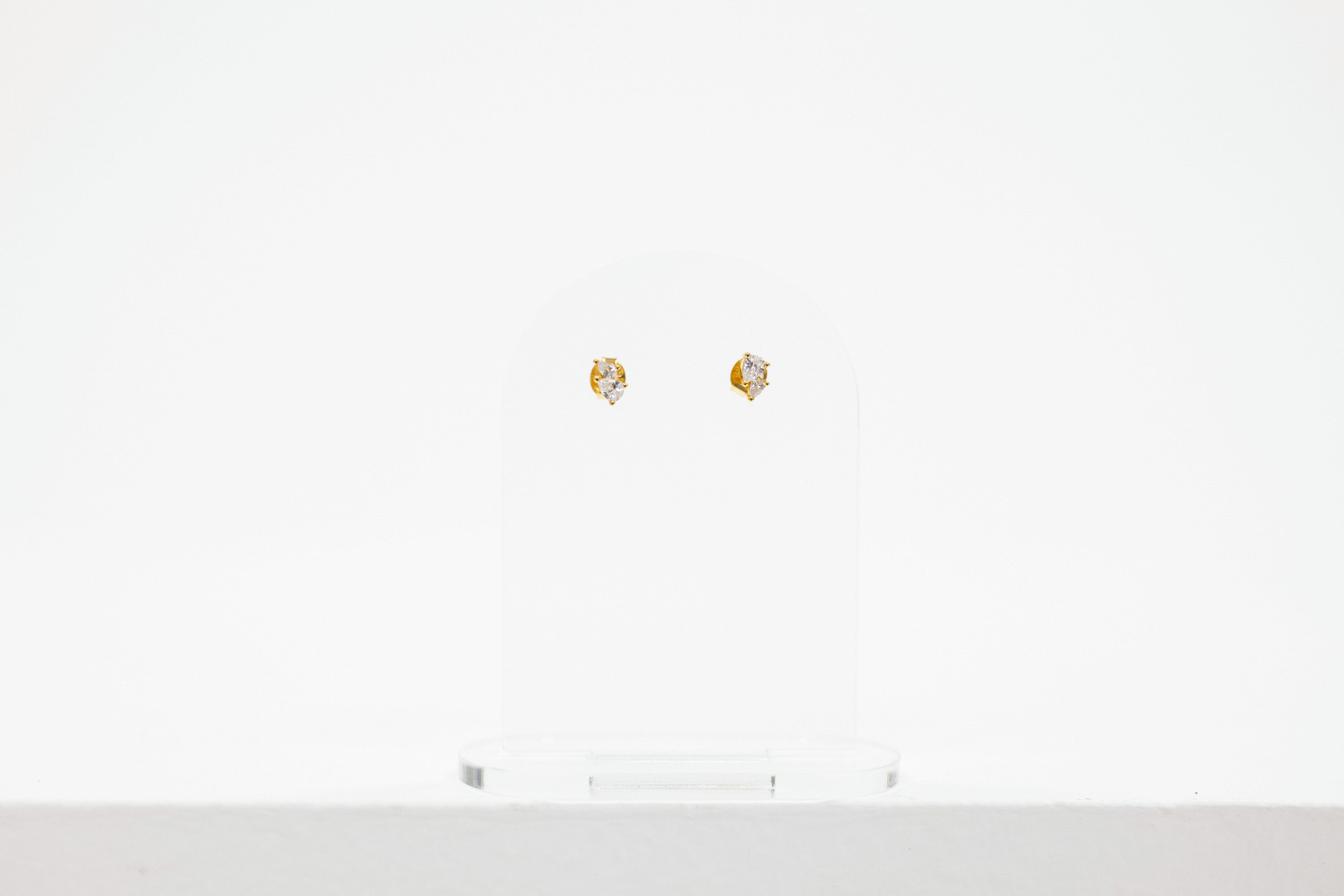 pair of stud earrings, each with a pair of cz stones
