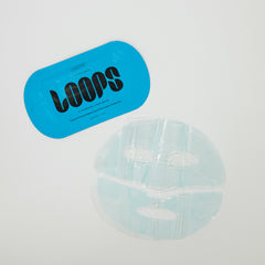 Sheet mask with blue 'LOOPS' label on a light gray background