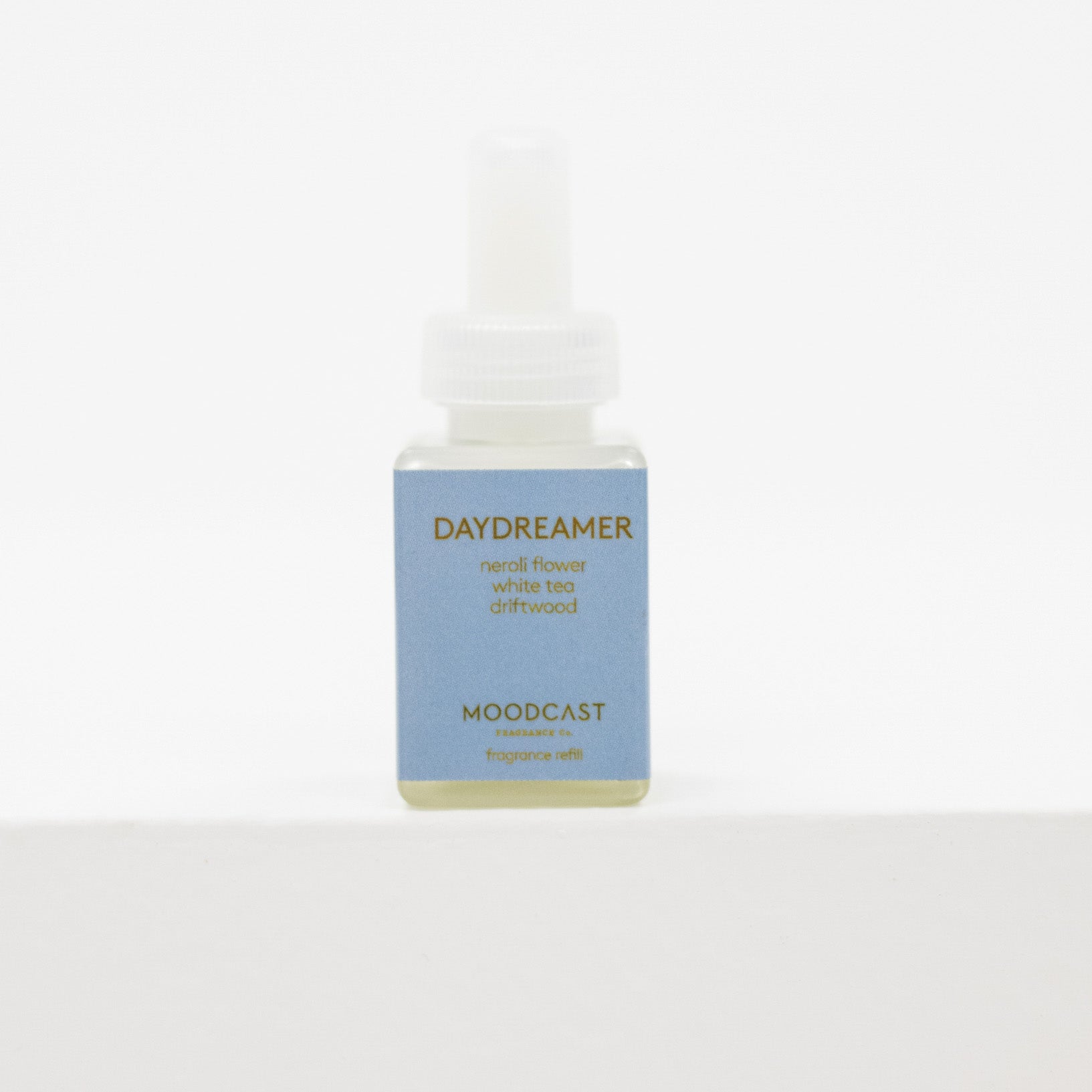 A small bottle of Moodcast Daydreamer pura fragrance oil with a light blue label and white dropper cap, set against a plain white background.