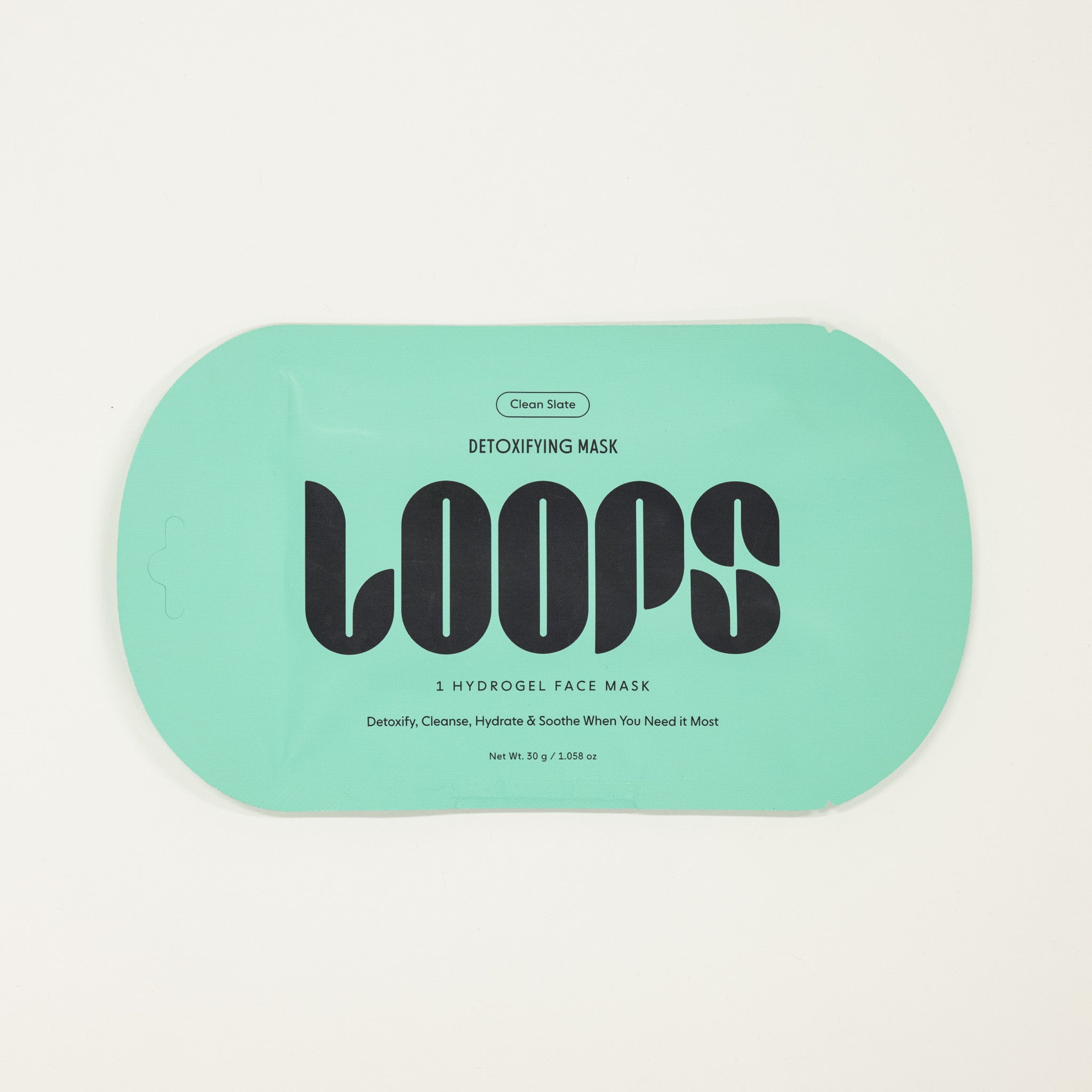 Loops detoxifying mask packaging on a light gray background