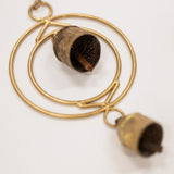 Gold circular pendant with chimes on a white background